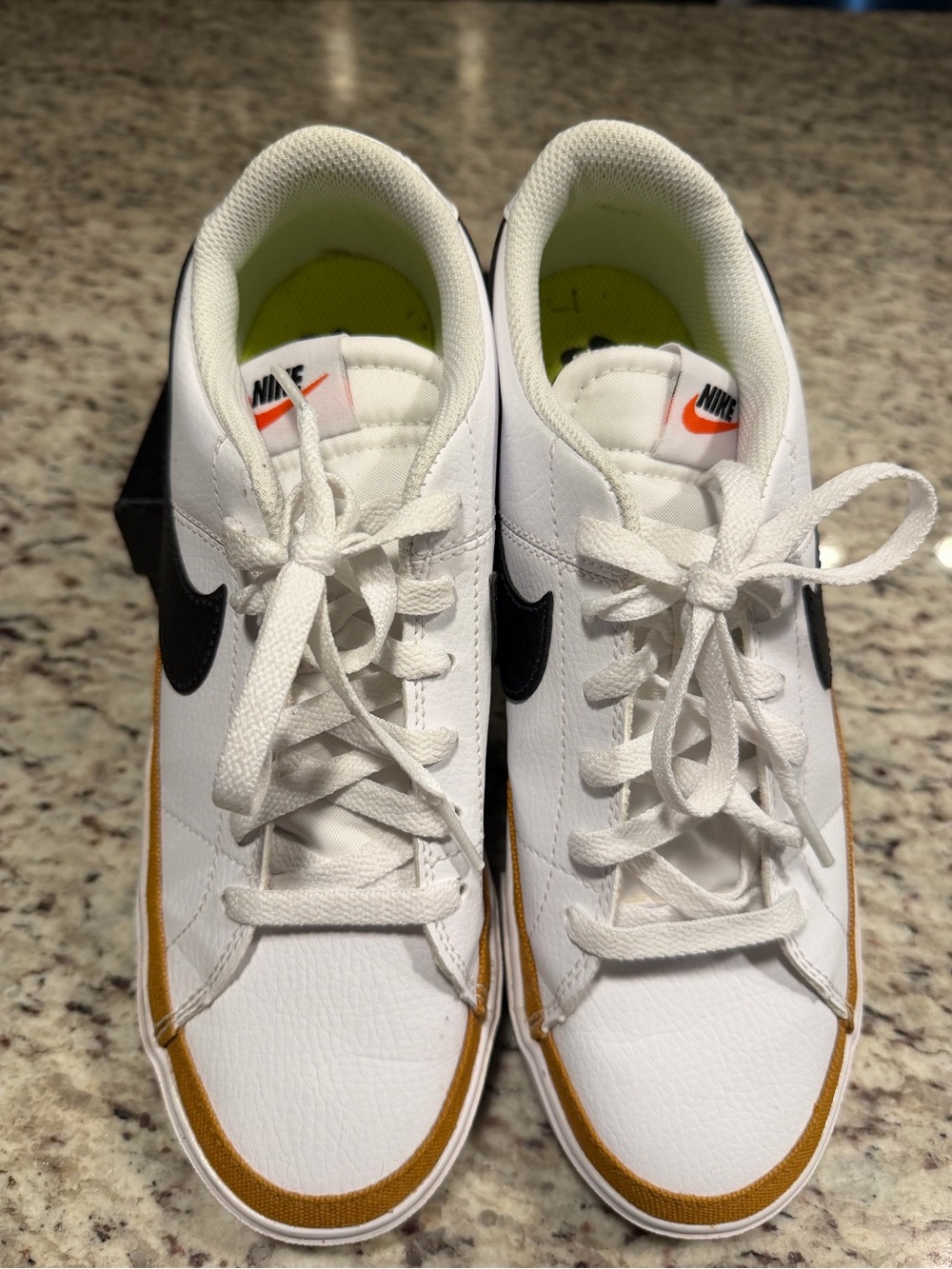 Nike Men’s White Sneakers with Black Swoosh and Gold Accent